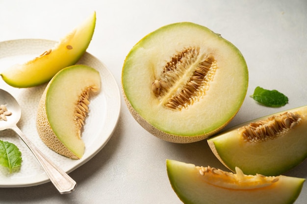 Cantaloupe melon fruit slice over bright background