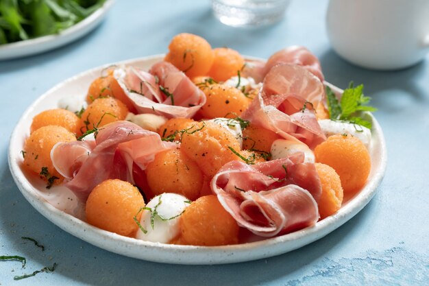 Cantaloupe melon salad with mozzarella and ham