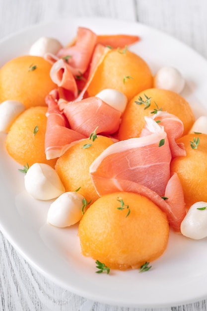 Cantaloupe melon with prosciutto and mozzarella appetizer