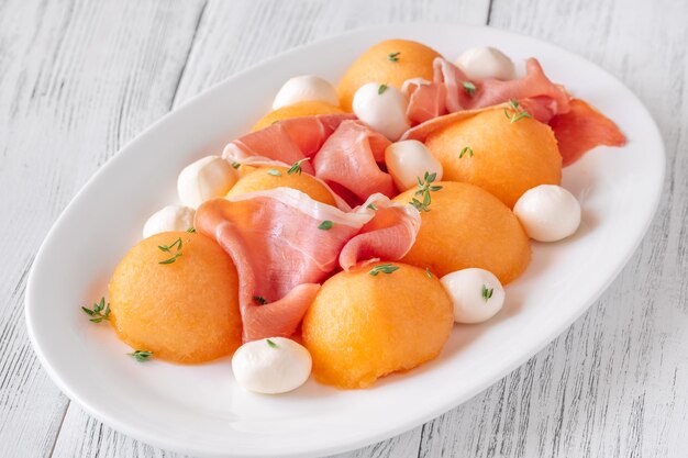 Cantaloupe melon with prosciutto and mozzarella appetizer