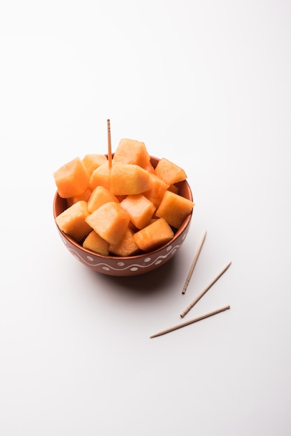 Cantaloupe or muskmelon or kharbuja cut into pieces, served in a bowl. selective focus