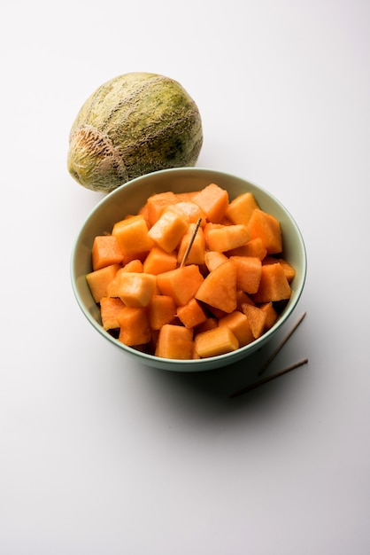 Cantaloupe or muskmelon or kharbuja cut into pieces, served in a bowl. selective focus