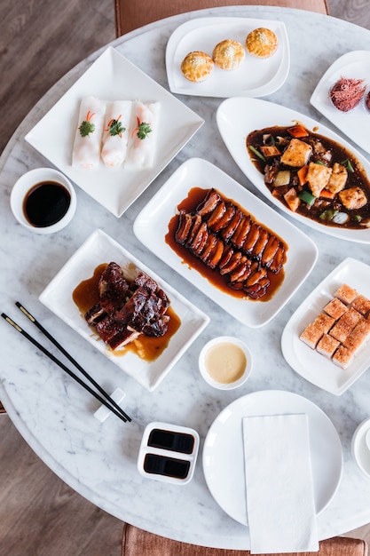 Cantonese meal on marble top round table.