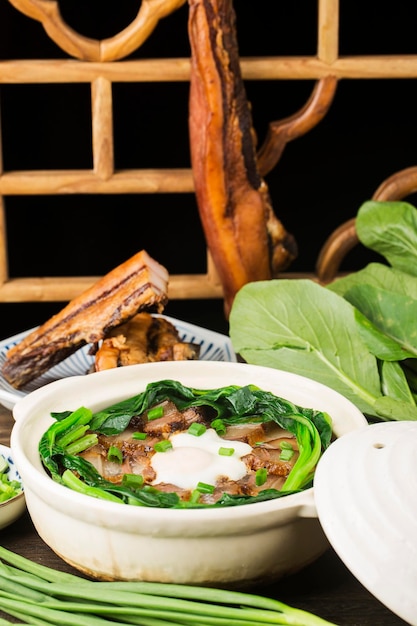 Cantonese style cooking of claypot rice with waxed meats