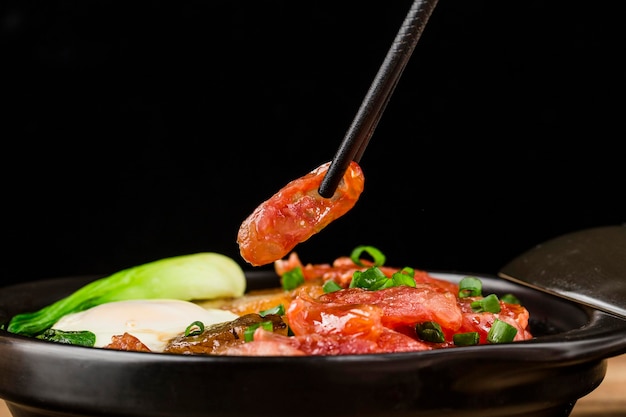 Cantonese style cooking of claypot rice with waxed meats