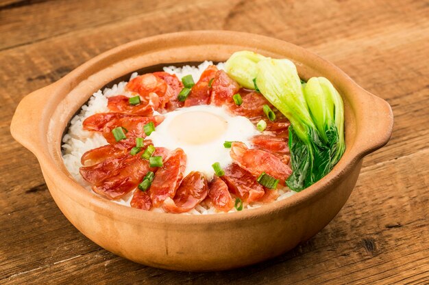 Cantonese style cooking of claypot rice with waxed meats