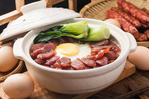 Cantonese style cooking of claypot rice with waxed meats