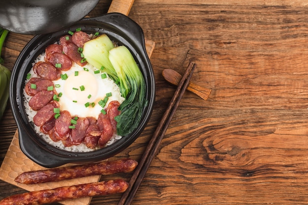 Cantonese style cooking of claypot rice with waxed meats