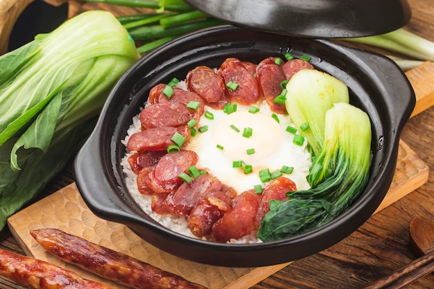 Cantonese style cooking of claypot rice with waxed meats