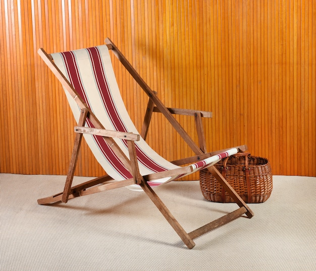 Canvas deck chair and wicker basket