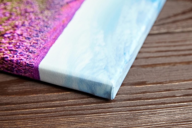 canvas photo print stretched onto frame on wooden background