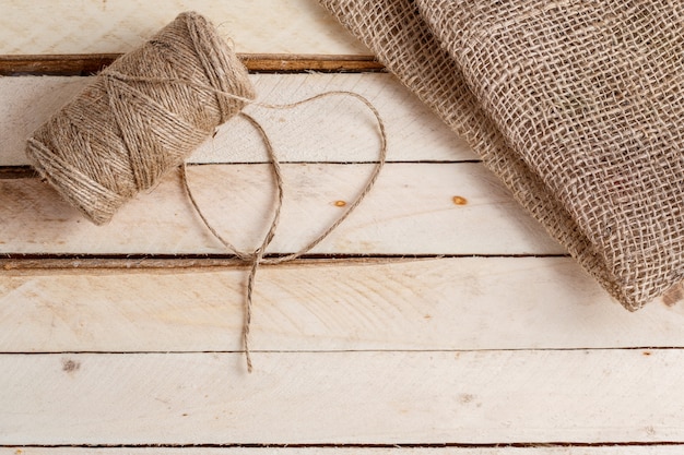 The canvas and the tangle of thread on a wooden surface