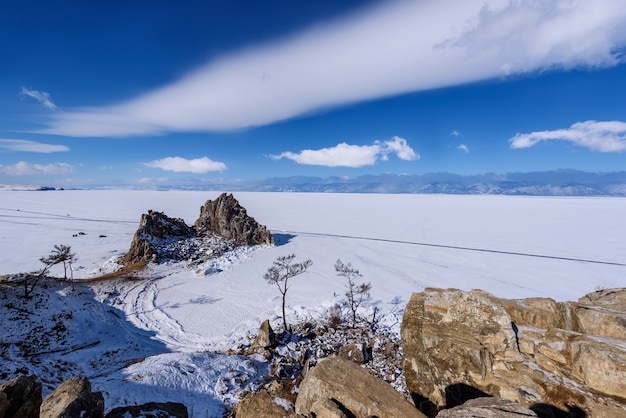 Cape Burhan on Shamanka Rock in Olkhon island in sunny march day. Lake Baikal with beautiful clouds