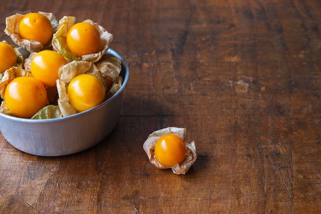 Cape Gooseberry fruit In a bowl on a wooden table