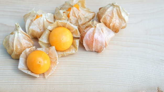 Cape gooseberry on wooden background, selective focus.