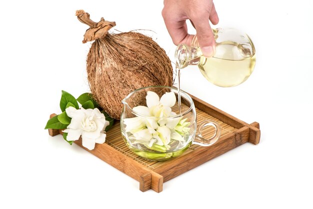 Cape jasmine or gardenia jasminoides flowers and oil isolated
on white background.