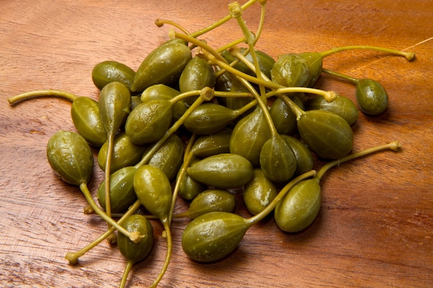 Caperberries close up on wood background