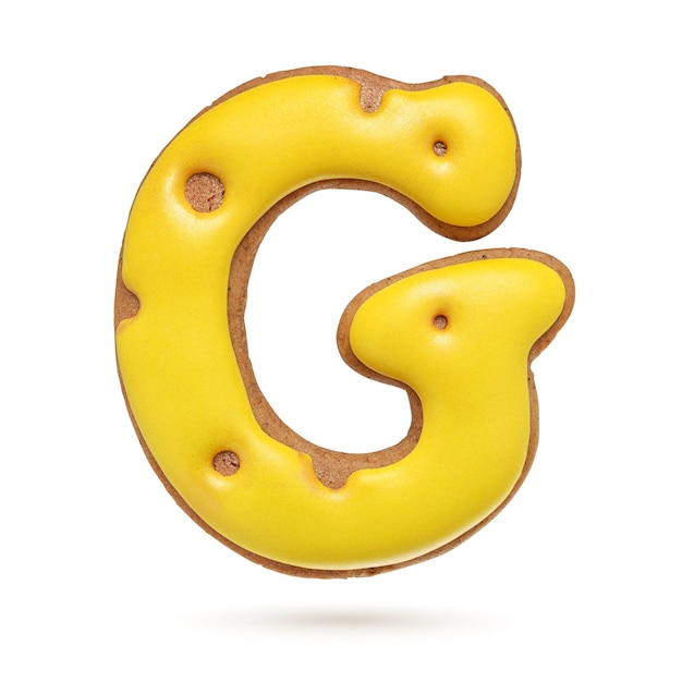 Capital letter G yellow homemade gingerbread biscuit isolated on white background