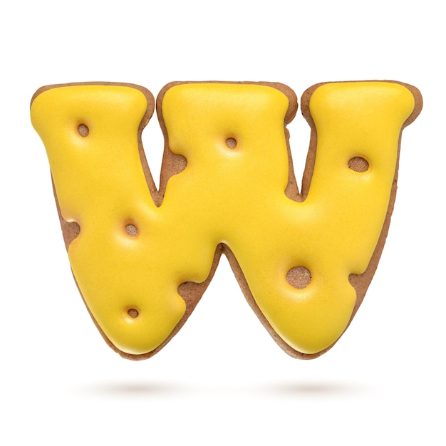 Capital letter W yellow homemade gingerbread biscuit isolated on white background