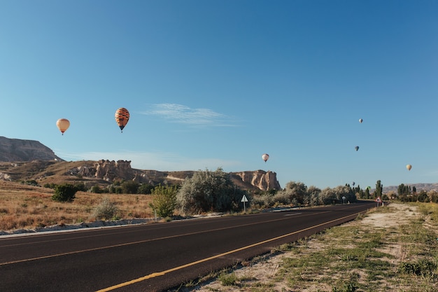 Cappadocia road balloons soar above it