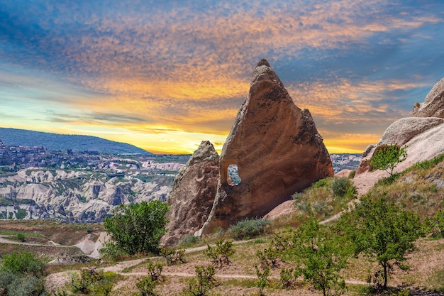 Cappadocia Turkey - stone pillars and cave houses at sunset