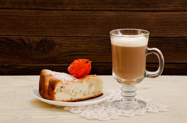 Cappuccino and apple pie on a wooden 