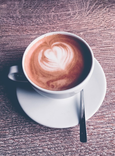 Cappuccino for breakfast in cafeteria coffee cup on table in\
parisian cafe