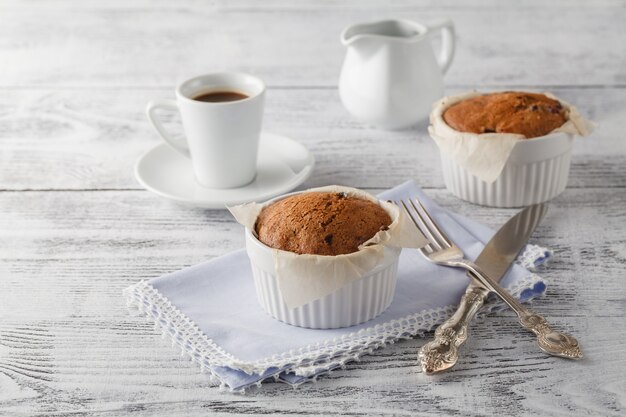 cappuccino coffee cup with muffin on white table