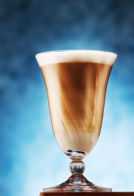 Cappuccino coffee in a glass goblet