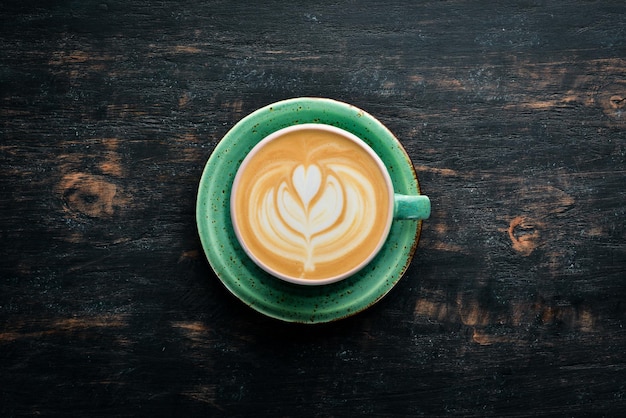 Cappuccino Coffee with milk On a black wooden background Top view Free copy space