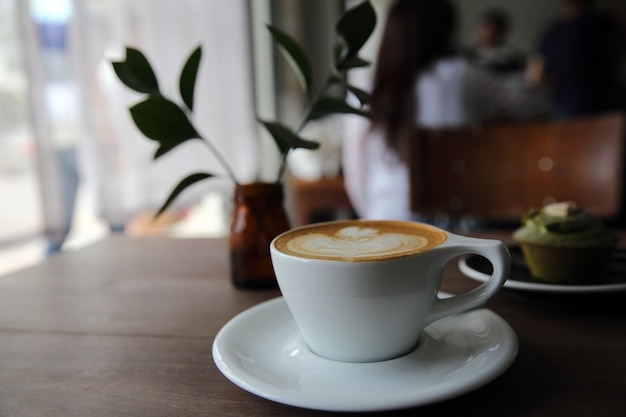 Cappuccino coffee on wood background