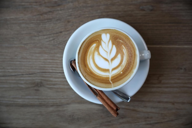 Cappuccino or Latte art coffee made from milk on the wood table in coffee shop with top view