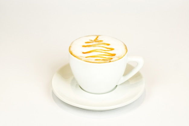 Cappuccino with a pattern on a fragrant foam in a white clock