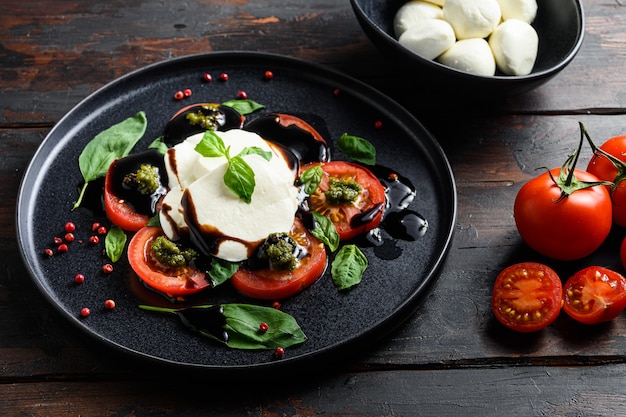 Caprese salad on black plate