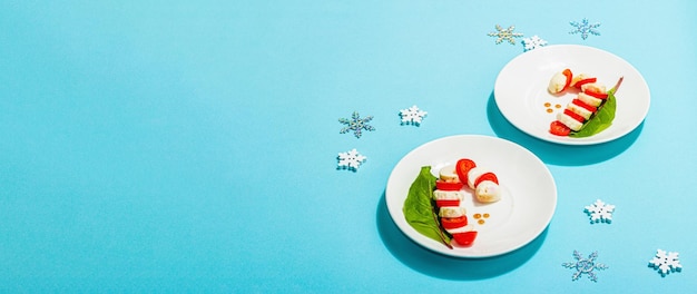 Caprese salad in form of a christmas candy cane traditional new year design festive decoration