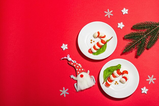 Caprese salad in form of a Christmas candy cane Traditional New Year design festive decoration