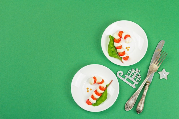 Caprese salad in form of a Christmas candy cane Traditional New Year design festive decoration