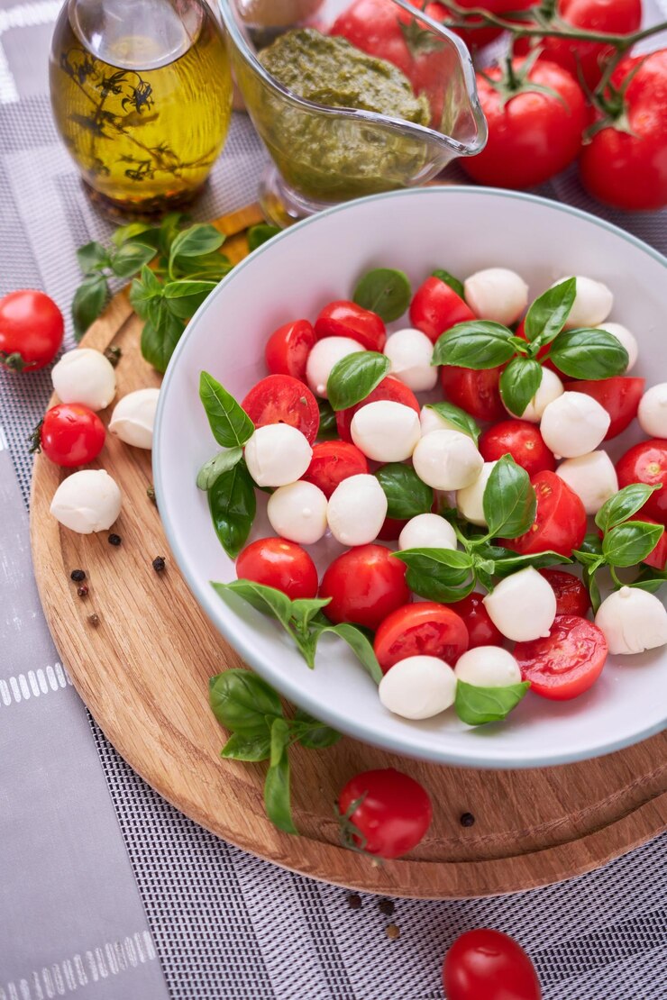 Caprese salad Mini mozzarella cheese in glass bowl tomato and basil