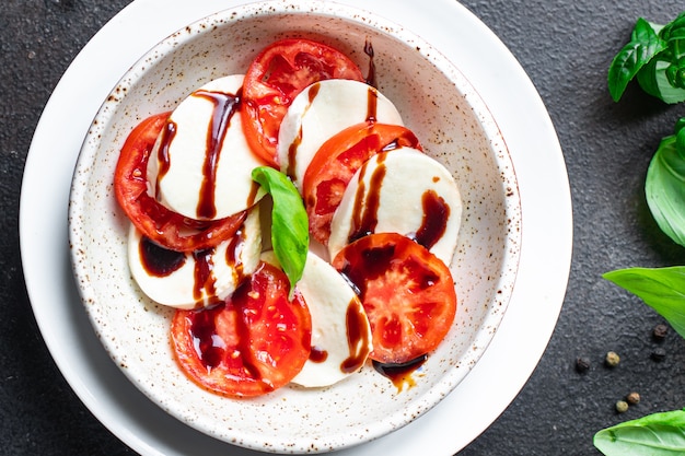 Caprese salad mozzarella cheese tomato basil leaf italian snack copy space food background rustic