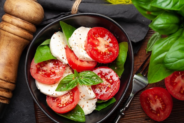 Caprese salad with fresh tomatoes garden basil and mozzarella cheese