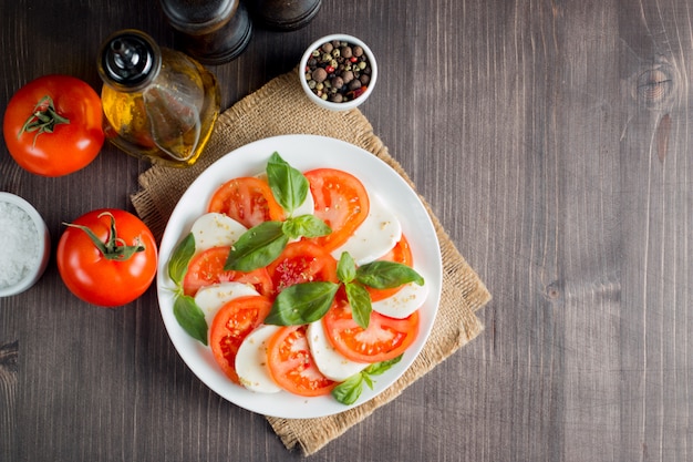 Caprese salad with tomatoes, basil, mozzarella cheese. 