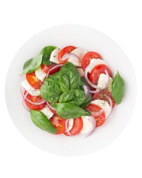 Insalata caprese con pomodori e mozzarella su un tavolo bianco