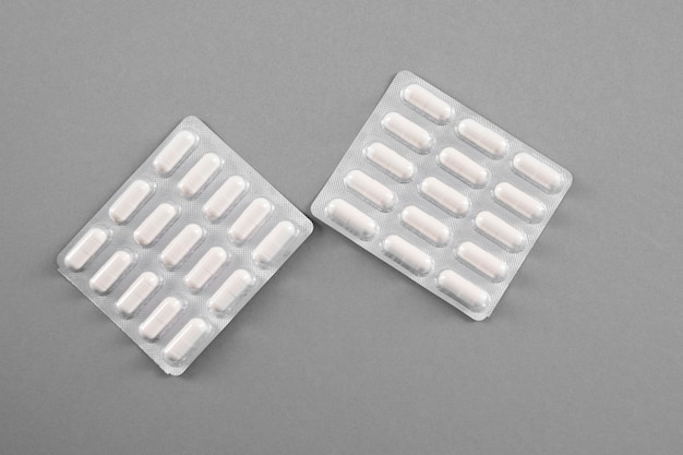 Capsules in blisters on a gray background