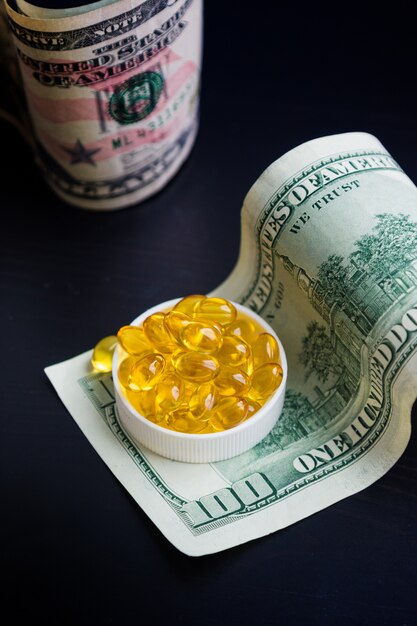 Capsules of fish oil and dollars 