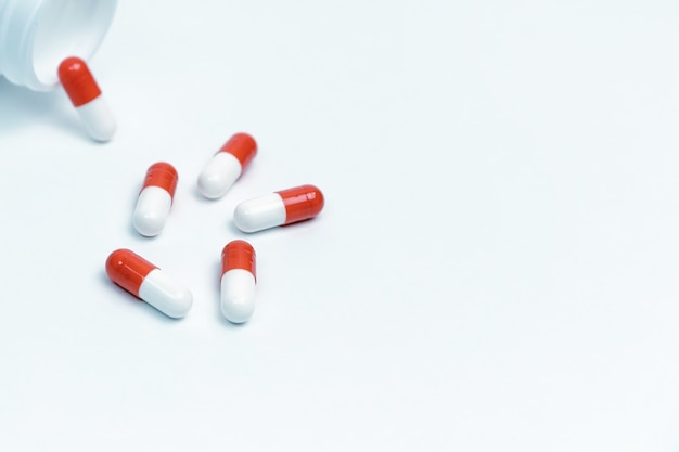 Capsules with medicine and a bottle on a white background. photo with a copy-space.