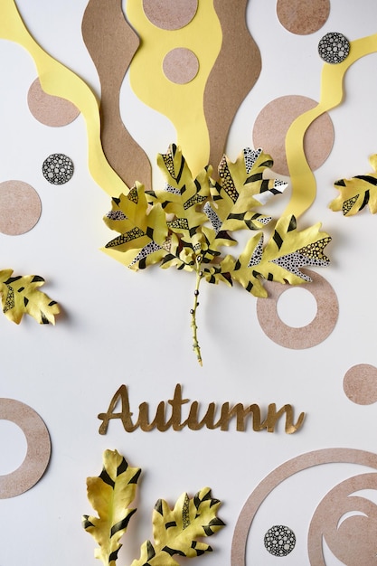 Caption text Autumn Geometric patterns painted on oak leaf Drawing on Autumn leaves Layered brown beige yellow organic shapes Flat lay top view abstract seasonal Fall background