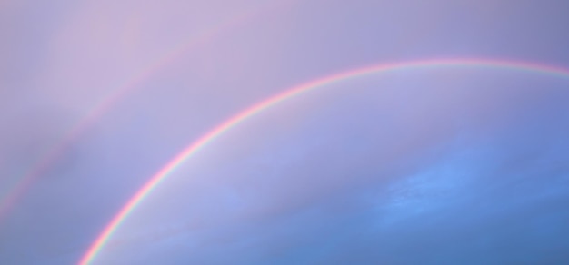 Captivating Double Rainbow in the Cloudy Sky