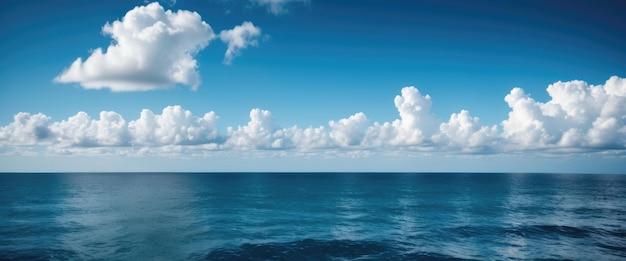 Capture the serene expanse of a blue sky with fluffy clouds drifting over the ocean