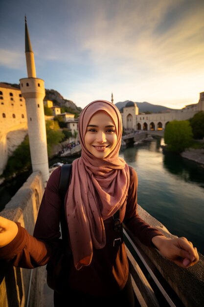 Photo capturing authentic moments a vibrant asean muslim girl immortalizes mostar old bridge at golden ho