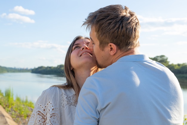 Capturing bright moments. Joyful crazy young funny loving couple making selfie on camera while